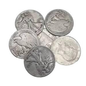 A collection of seven old silver coins with visible, but worn, engravings.