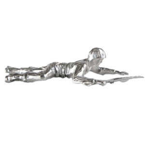 Metal figurine of a person lying prone, holding a long object.